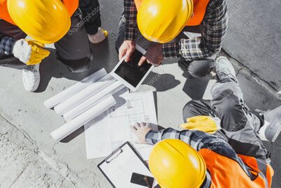 Engineers collaborating on an industrial machine design in a modern R&D office