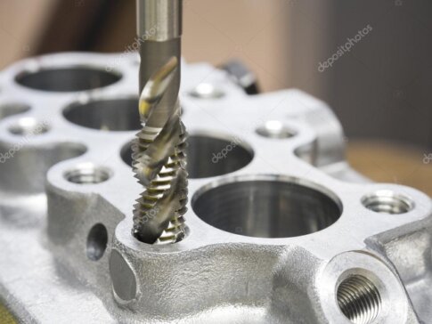High-precision metal components being machined on a CNC turning center