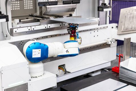 Collaborative robot tending a CNC machine in a modern factory