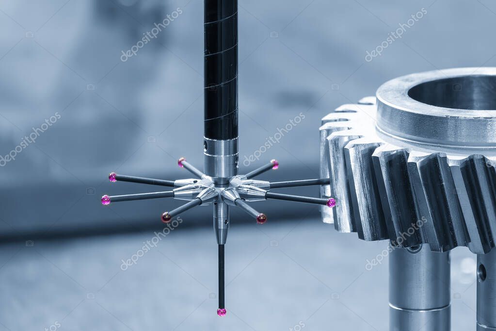 Operator performing quality control on a precision machined metal component